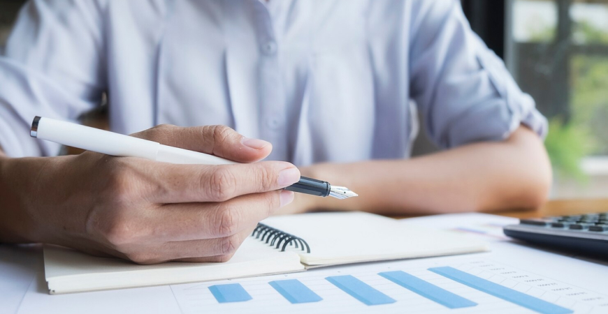 Pessoa analisando gráficos e fazendo planejamento tributário para proteger o caixa da empresa